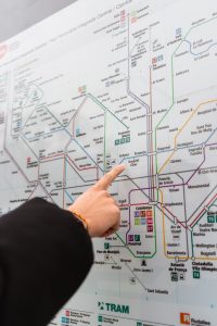 A hand pointing at a metro map