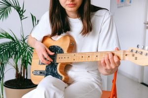 A woman playing the guitar