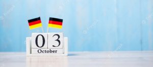 Picture of the date, 03, October and two German flags on top of the date holder.