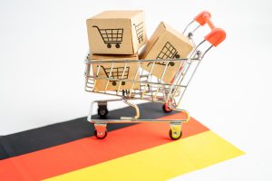 Picture of a small shopping cart on the corner of a small German flag